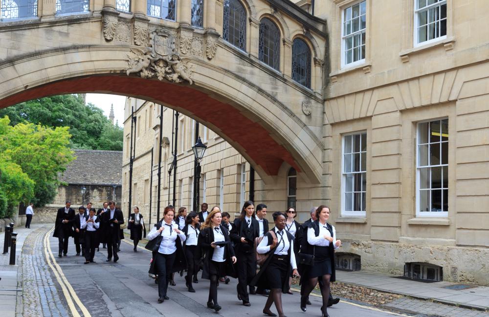 Oxford students dressed for final exams walk through the city.