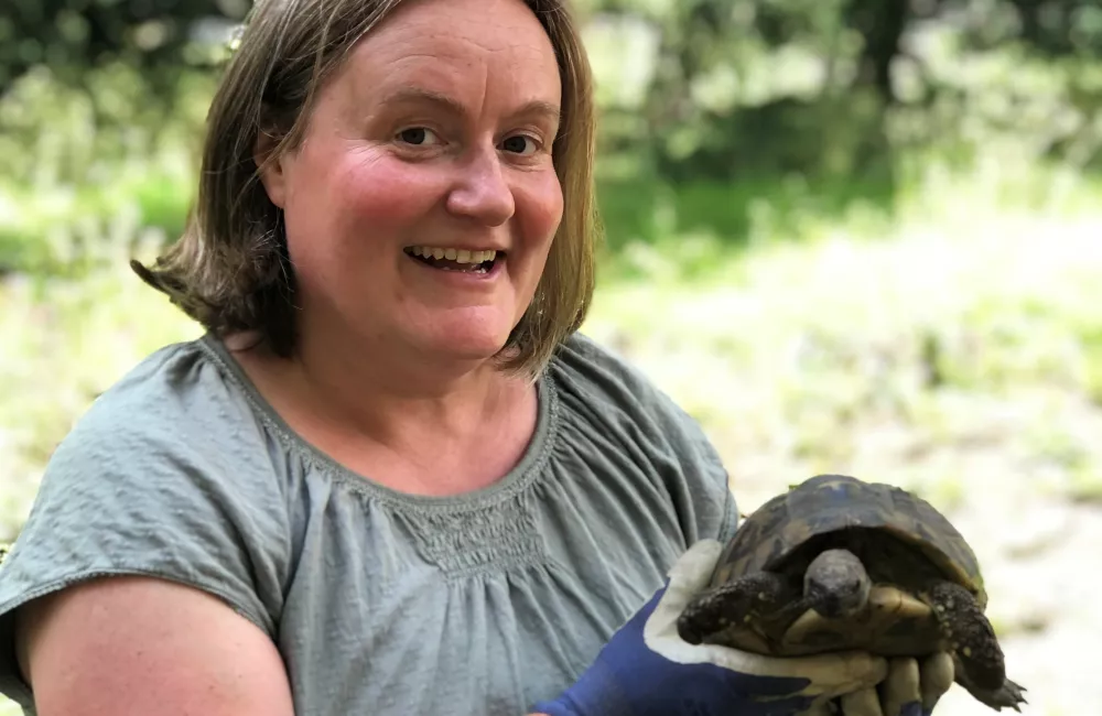Kate Burtonwood holds a college tortoise.