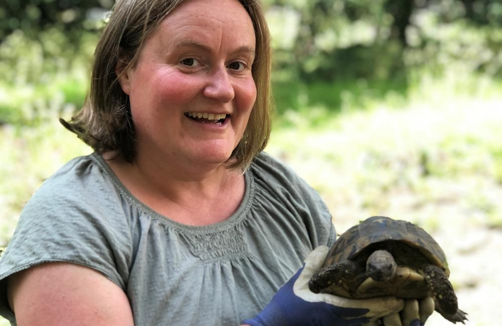Kate Burtonwood holds a college tortoise.