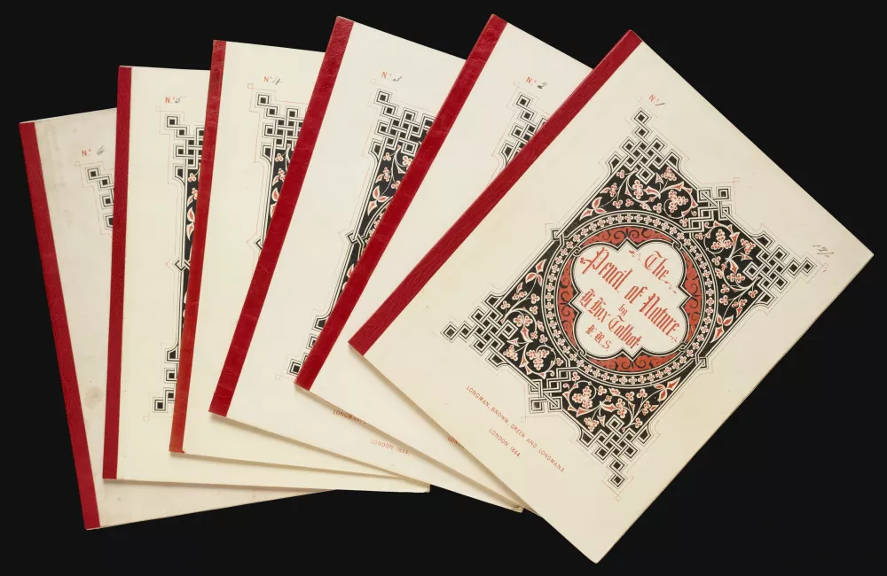 A small pile of copies of The Pencil of Nature by William Henry Fox Talbot.