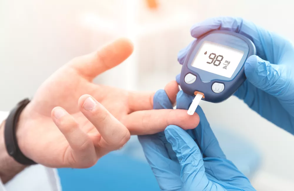 Doctor checking blood sugar level with glucometer