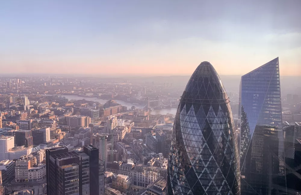 The London city skyline with the Gherkin and Shard buildings in the foreground.