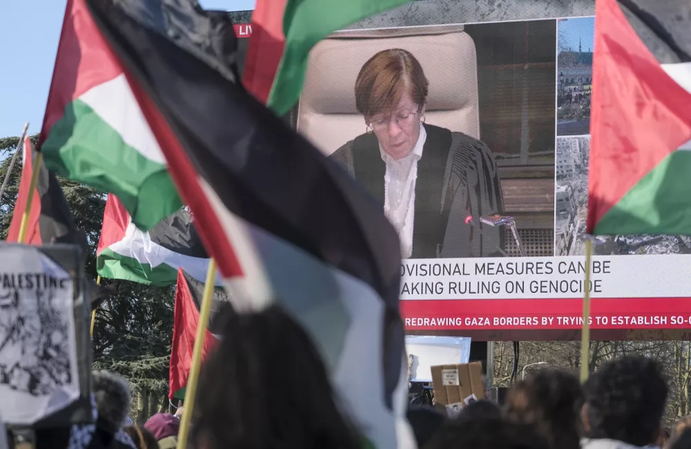 A crowd waving Palestinian flags outside a broadcast of the International Court of Justice ruling on South Africa's case against Israel.