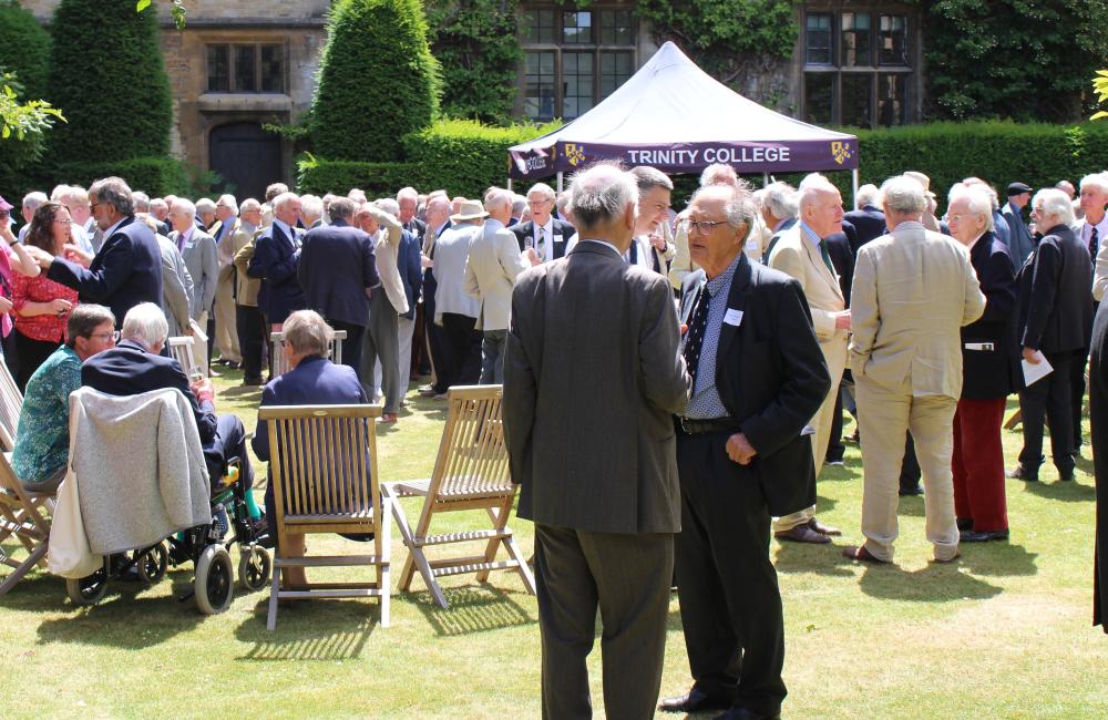 Attendees at Fifty plus lunch enjoying drinks in the Presidents Garden