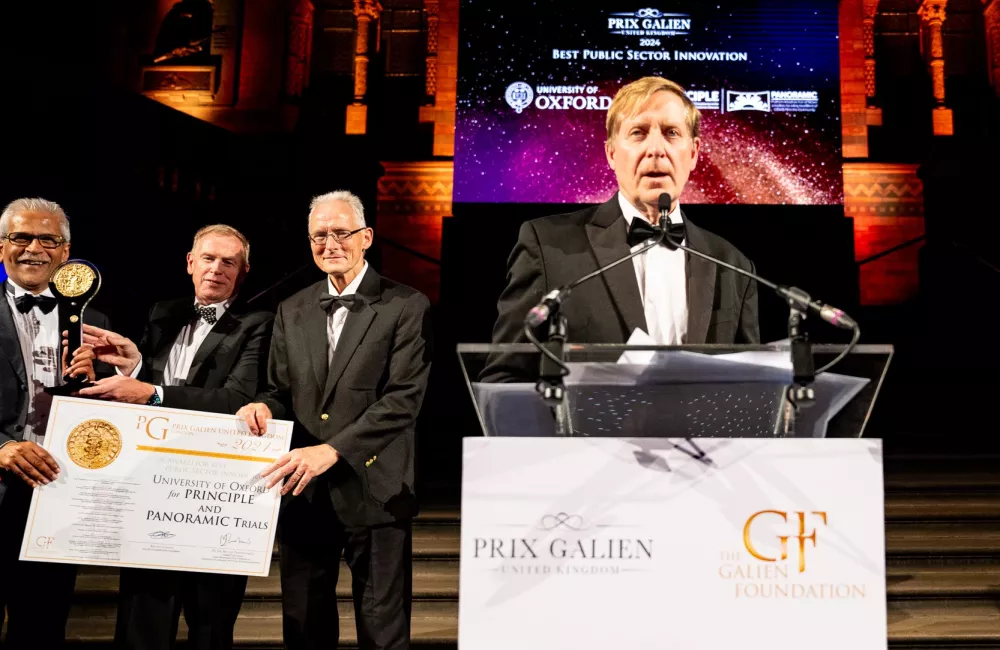 Professor Chris Butler stands giving a speech after receiving the Prix Galien Award.