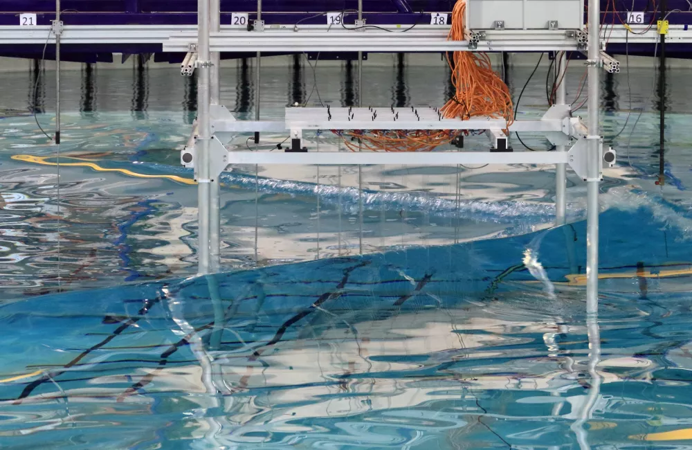 A wave breaking in the FloWave circular basin research facility.