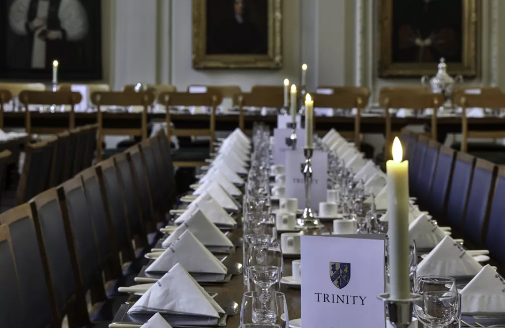 Tables in Hall laid up for dinner with napkins and candles