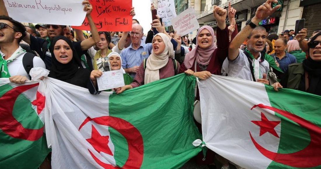 People with Algerian flags