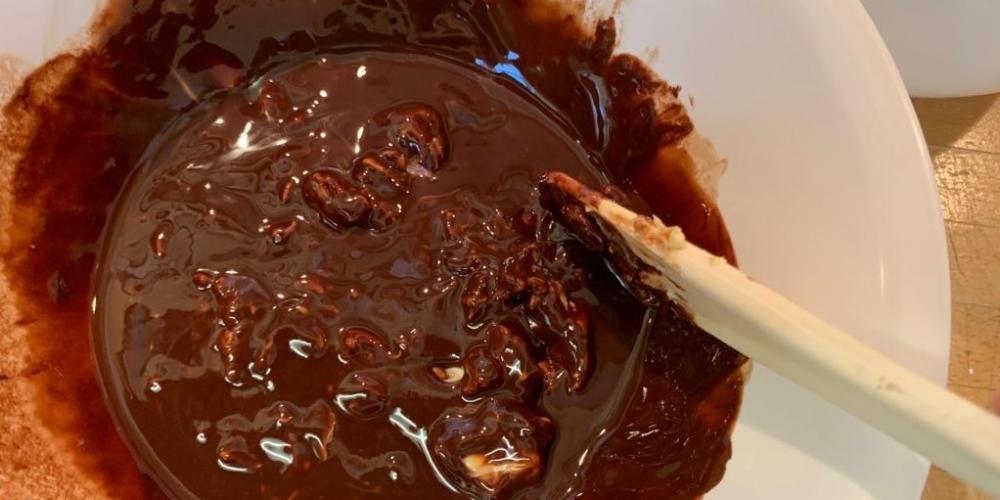 A melted chocolate mixture being stirred.