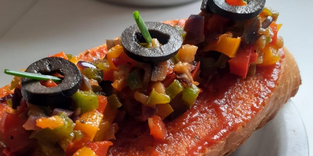 A bruschetta with ratatouille topping.