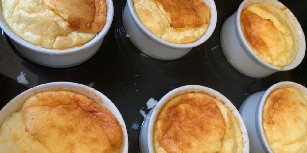 A tray of cooked cheese souffle ramekins.