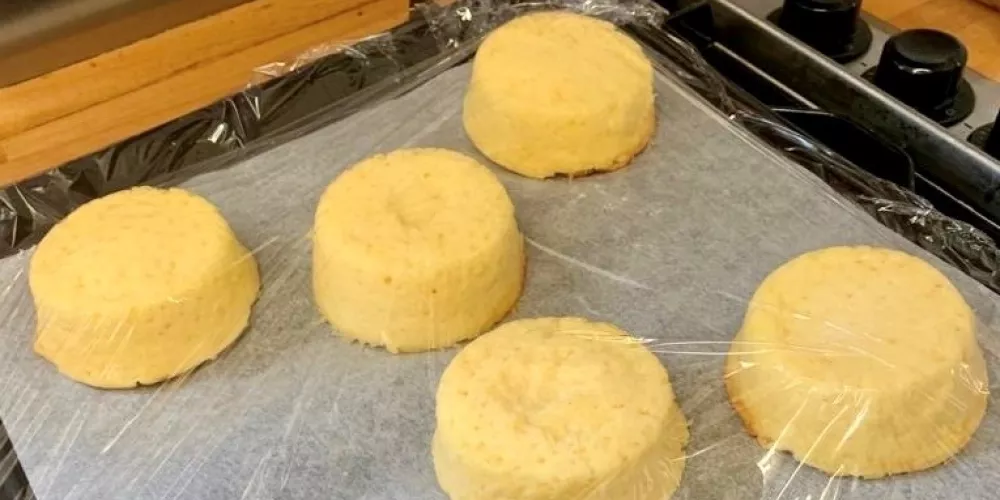 A tray of overturned cheese souffles, ready for sauce to go on top.