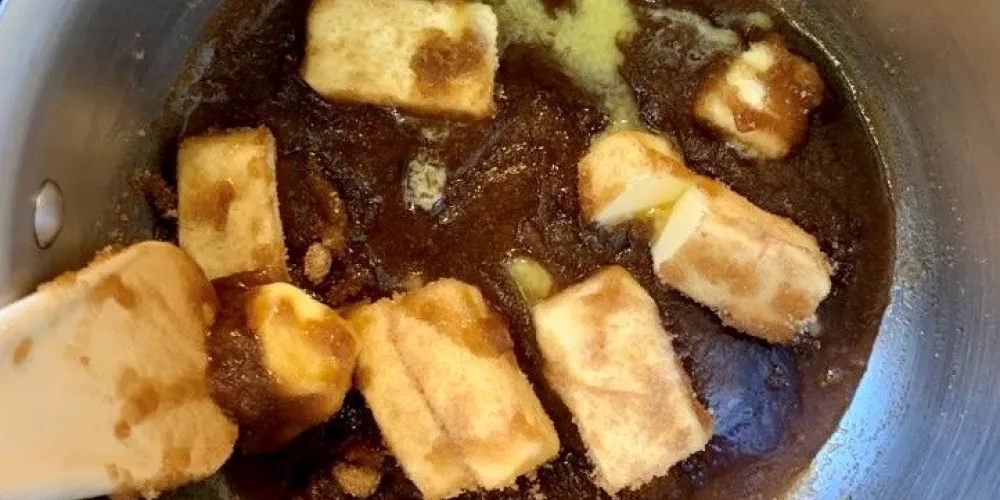 Butter and sugar on the hob being cooked and melted together.