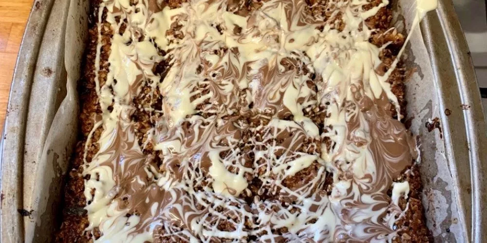 The finished flapjacks are drizzled with white and milk chocolate.