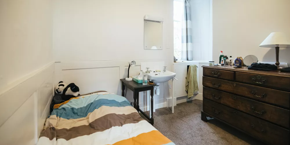 A first-year bedroom with colour-block striped duvet.