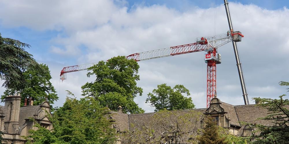 A giant crane looms over the top of the Trinity College grounds.