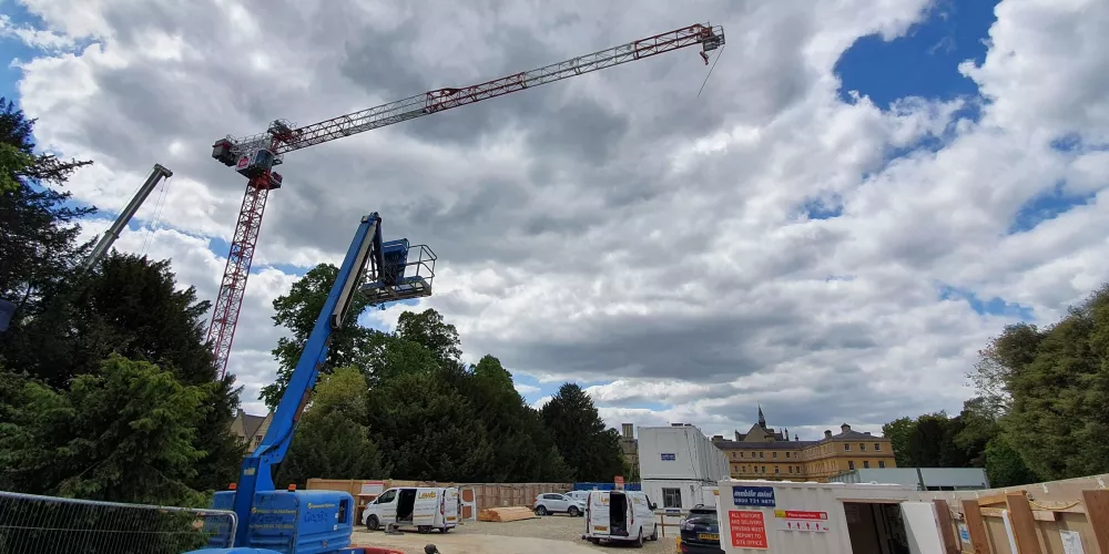 The giant crane towers in the sky above the Levine Building site.