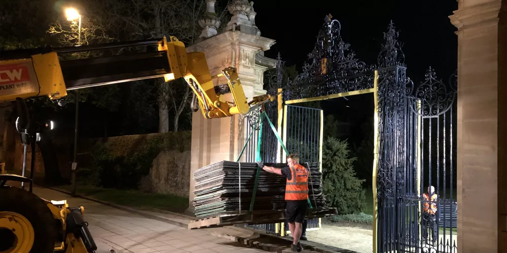 A truck drives building materials through the open Stuart Gates space.