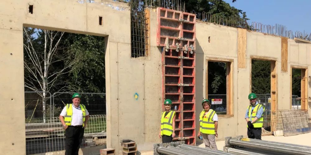 Trinity college staff stand in front of what will be the new beer cellar in the Levine Building.
