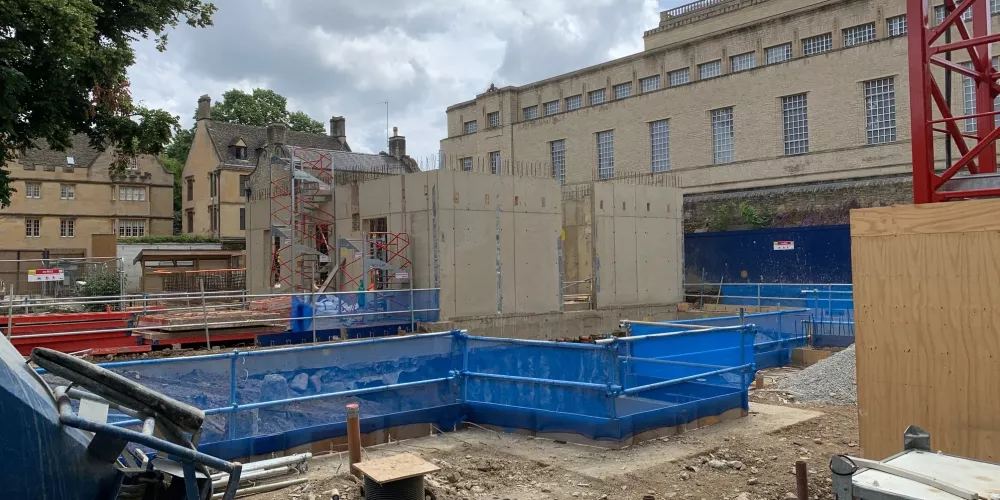 A view of the digging around the Levine Building site, with the Weston Library in the background.
