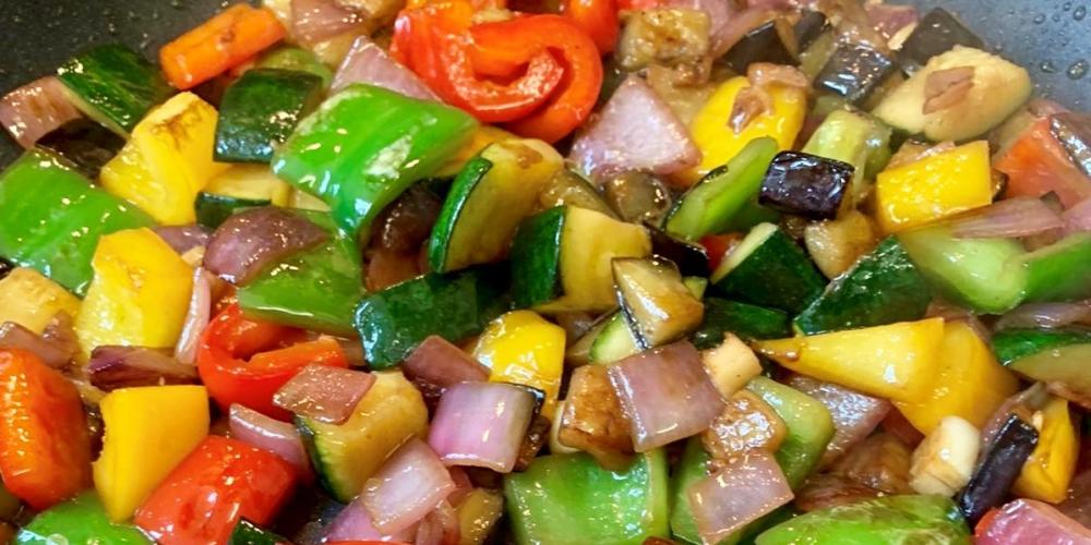 A pan of frying mixed vegetables.