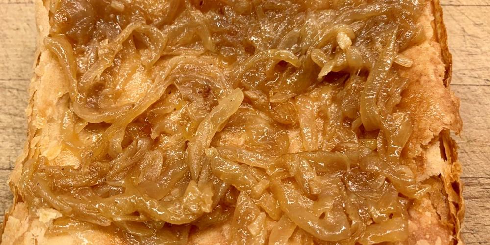 A phyllo crust with sauteed onions on top.