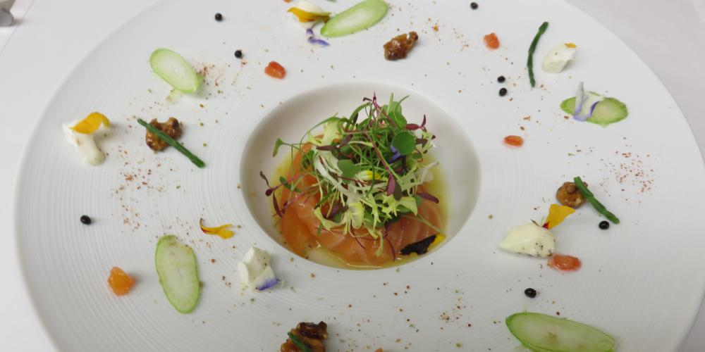 A plate of fennel-cured salmon with galliano-glazed walnut, orange and goats cheese salad.