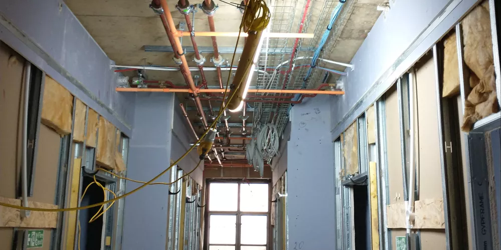 A view inside the newly wired electrical cabling in a hallway of the Levine Building. 