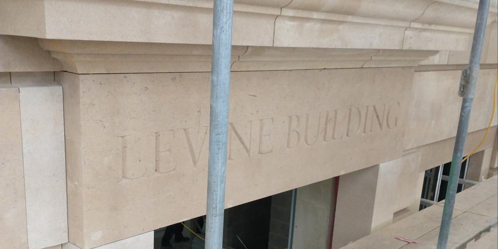 A section of the stonework in the Levine Building, with the words "Levine Building" carved into the stone.