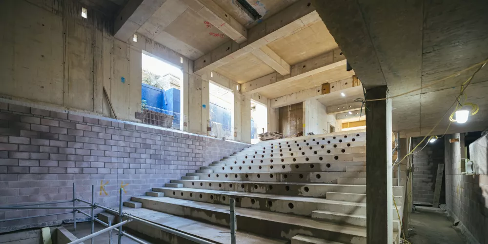 A view inside the basement auditorium in the Levine Building from the bottom of the theatre stairs.