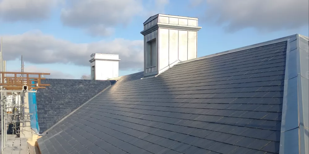 The roof of the Levine Building in spring 2021, complete and tiled in black slate.