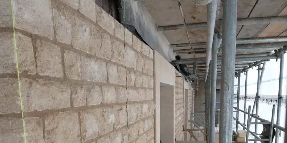 A view along the stone side of the Levine Building with scaffolding still up but sandstone in place.
