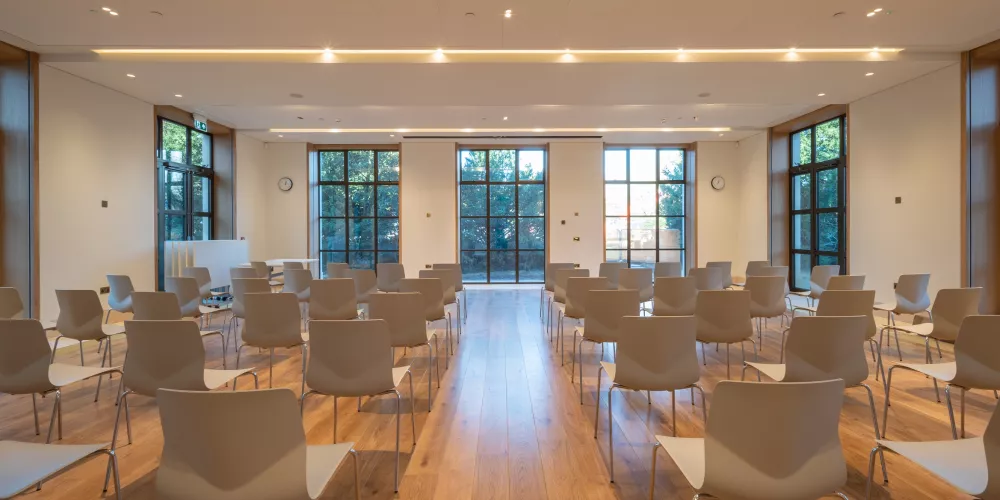 Seating arranged in the Levine Building garden room for a lecture.