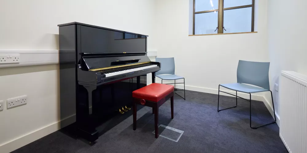 The piano and setup in Music Room 1 of the levine building.