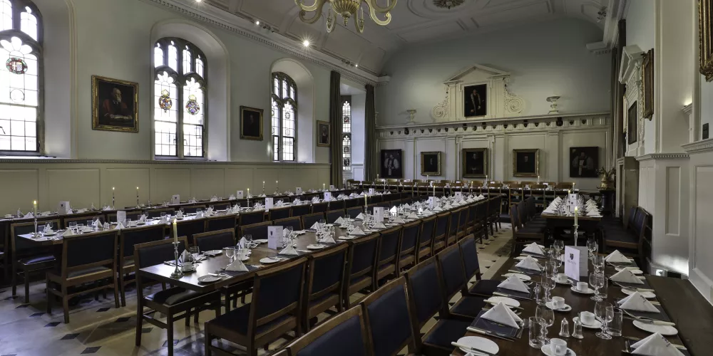 The Trinity dining hall set for a formal meal.