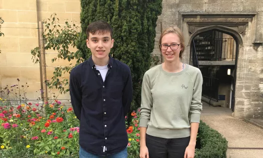 A male and female fresher stand next to each other in Trinity's front quad.