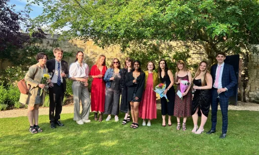 A group of modern languages students with tutors in the Trinity President's Garden.