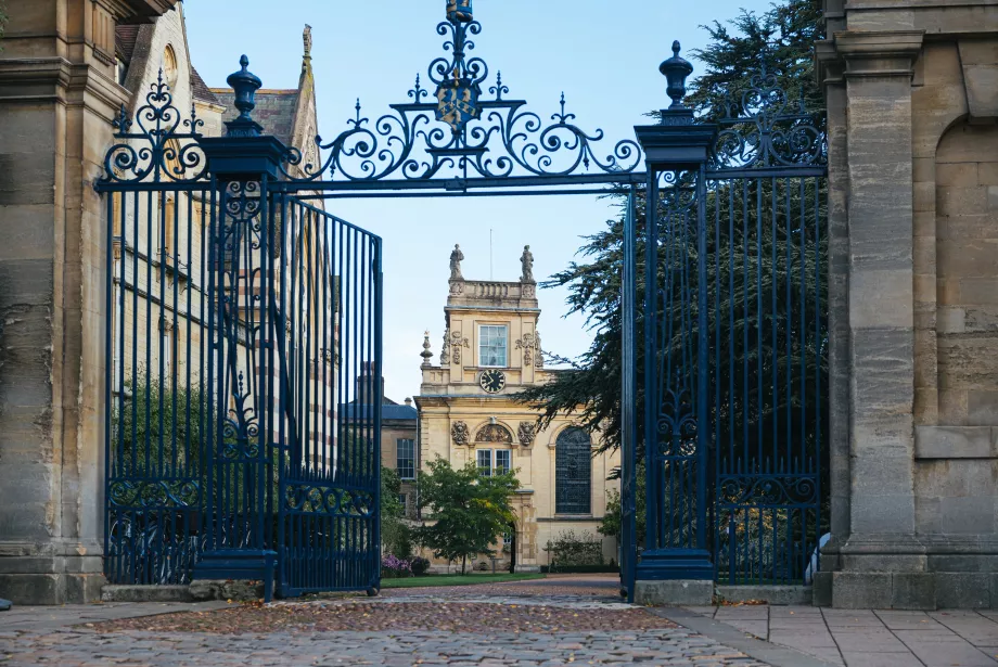A view of Trinity College's Front Quad and chapel tower through its open front gates.