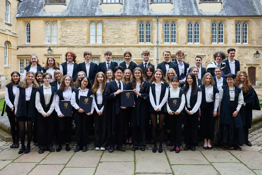 The Trinity chapel choir stand in sub fusc in the college's Durham quad.