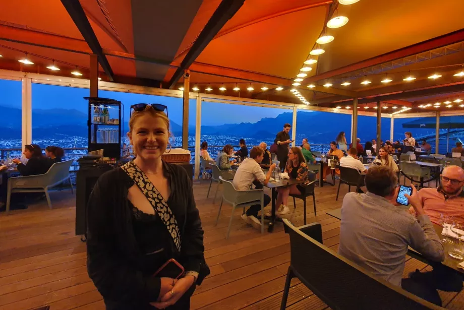 Trinity postgraduate Ishbel Henderson stands in a restaurant in the evening.