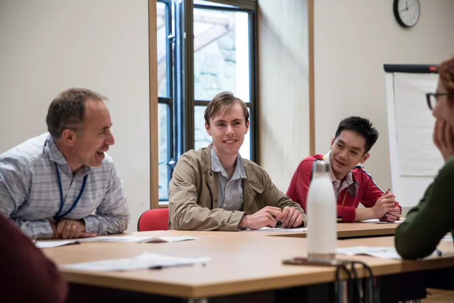 A teacher leads a discussion session in a classroom.