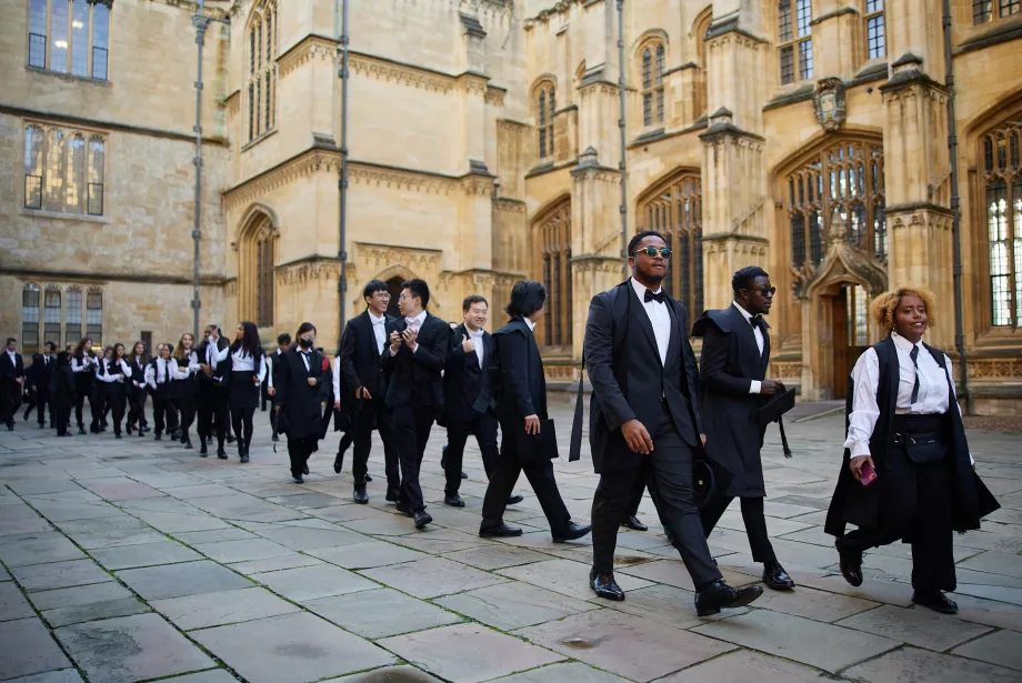 Trinity College MCR members walk in a line during matriculation. 