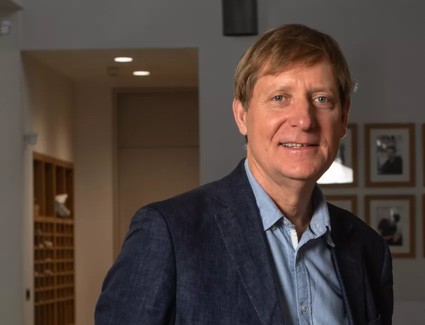 Chris Butler stands in the lobby of the Department of Primary Care.